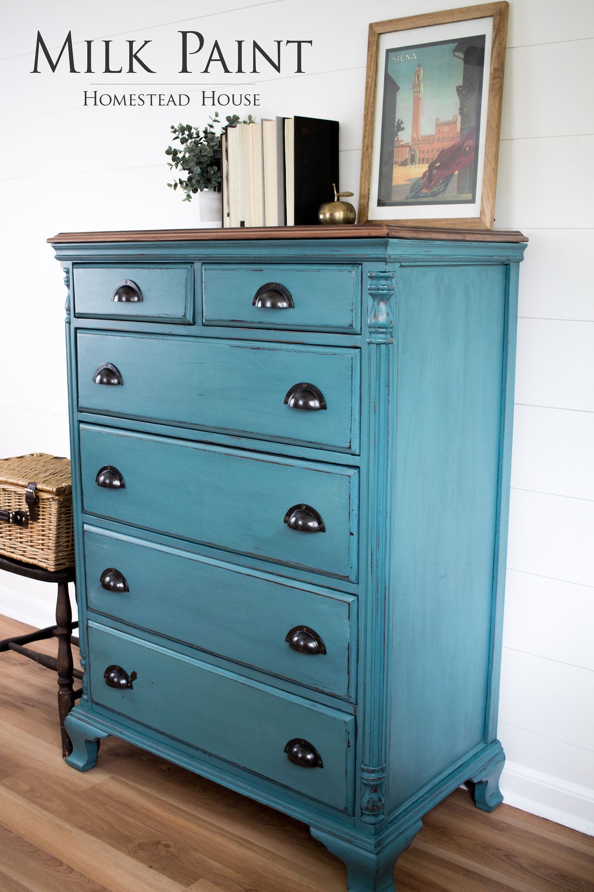 Six-drawer dresser painted Renfrew Blue Milk Paint by Homestead House, decor on top, wicker basket on chair nearby.