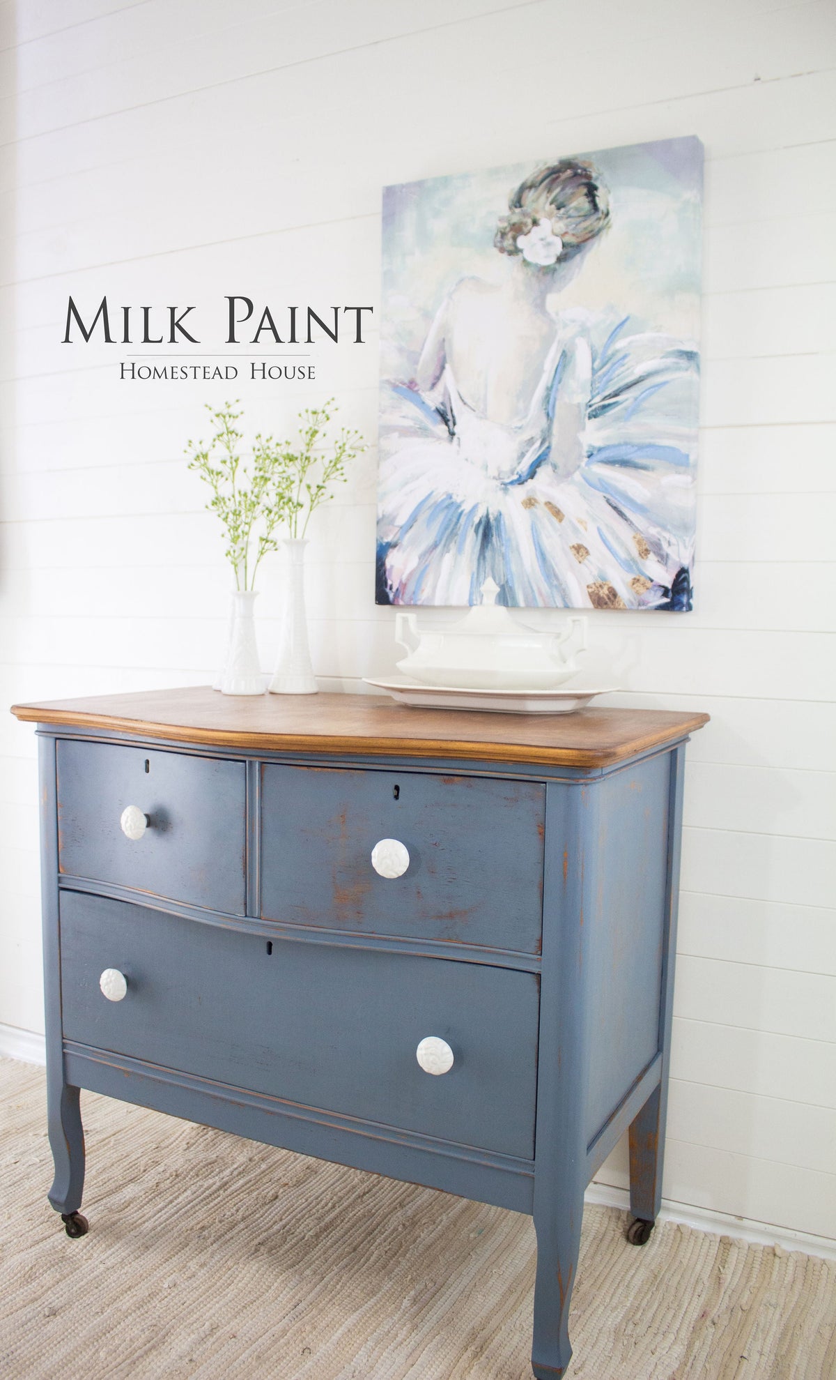 Dresser in Homestead House Rideau Blue Milk Paint with white knobs, topped with a vase and ballerina art.