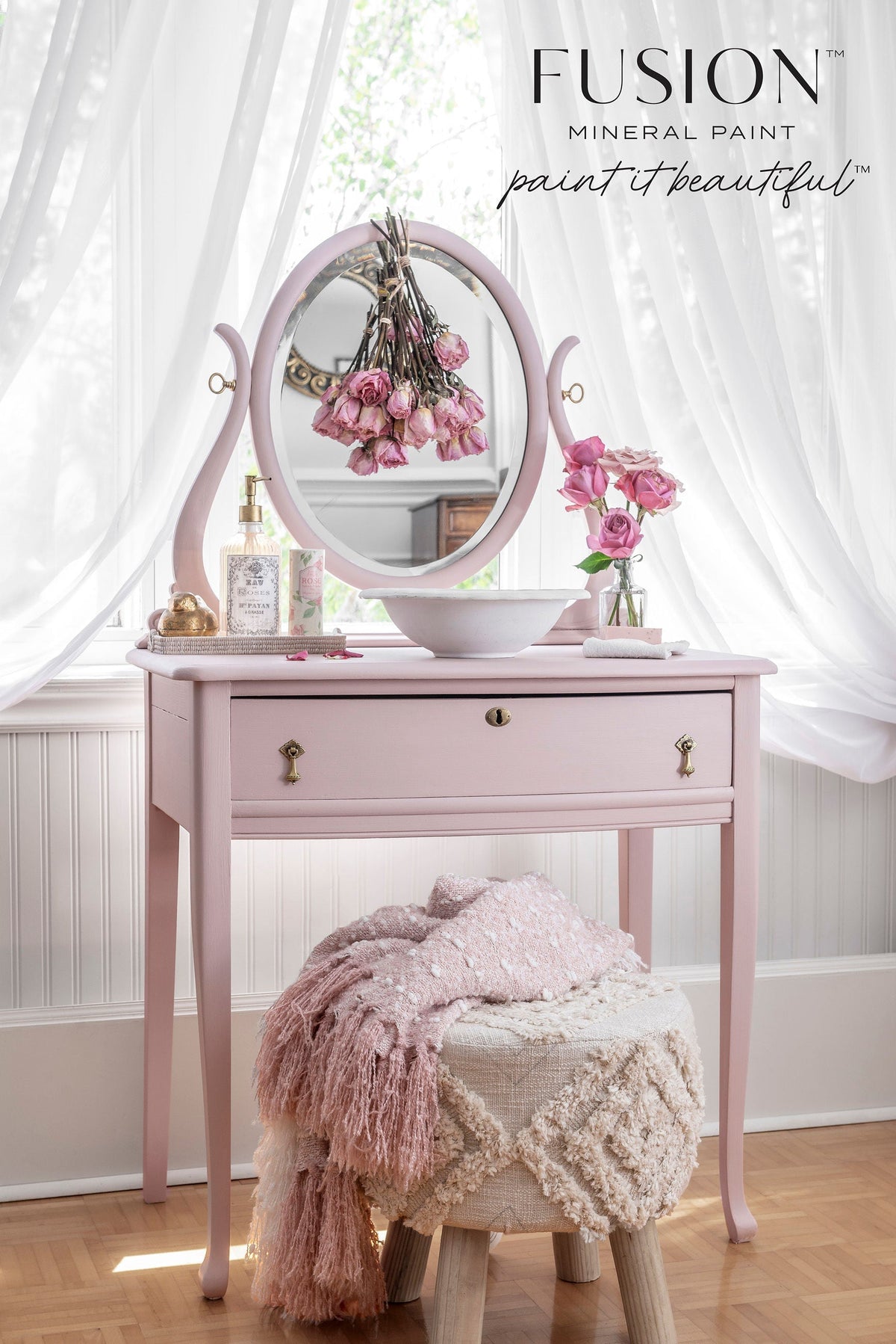 Neutral pink vanity in Fusion Mineral Paint Rose Water by sheer curtains, with a textured stool nearby.