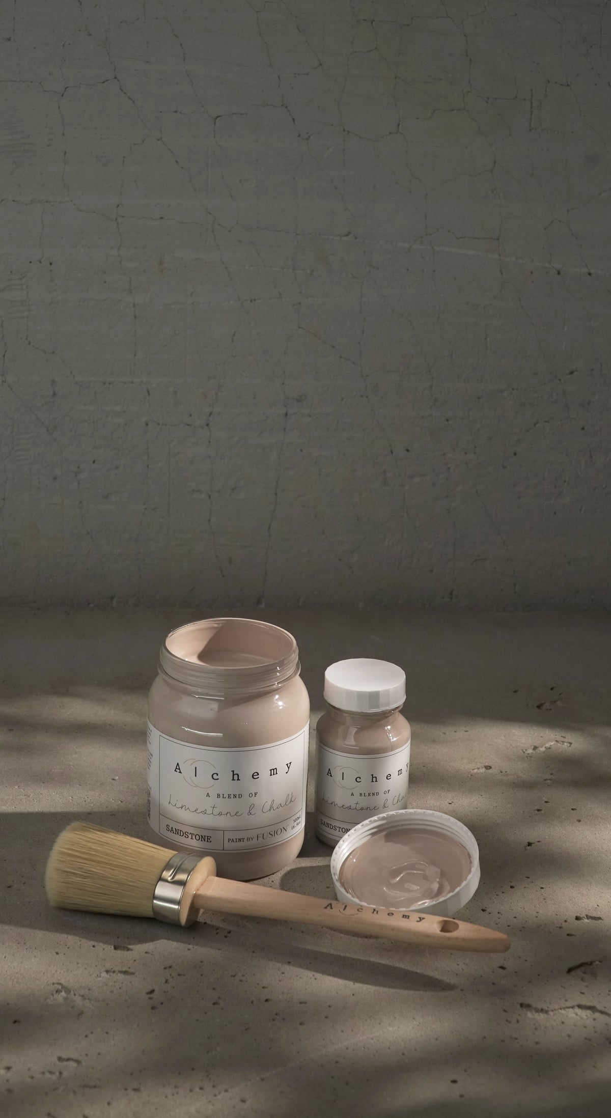 Two jars of Fusion Mineral Paint Sandstone Alchemy, one open with brush inside.