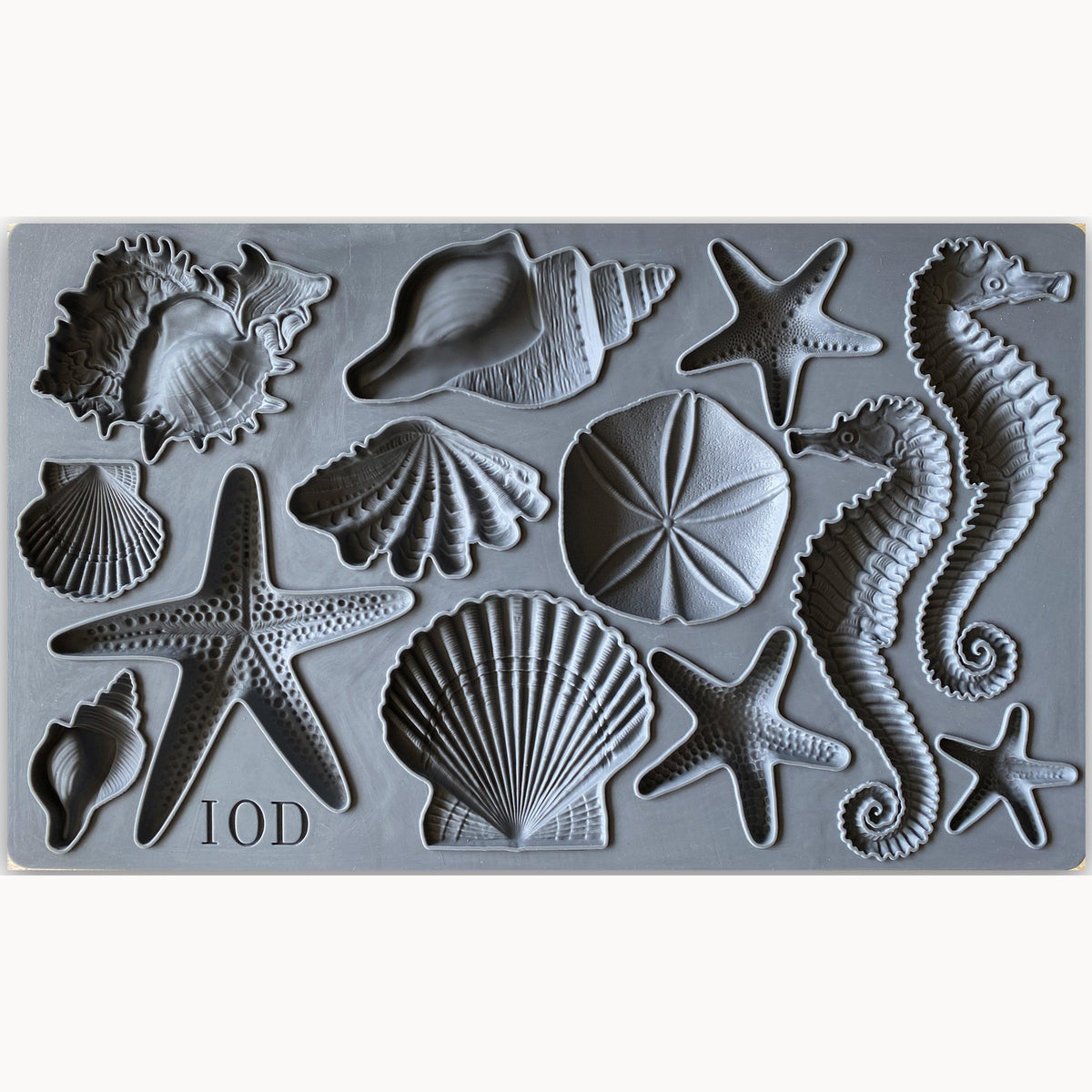 I.O.D. Sea Shells Mould with starfish, seahorses, sand dollars, and shells arranged in rows.