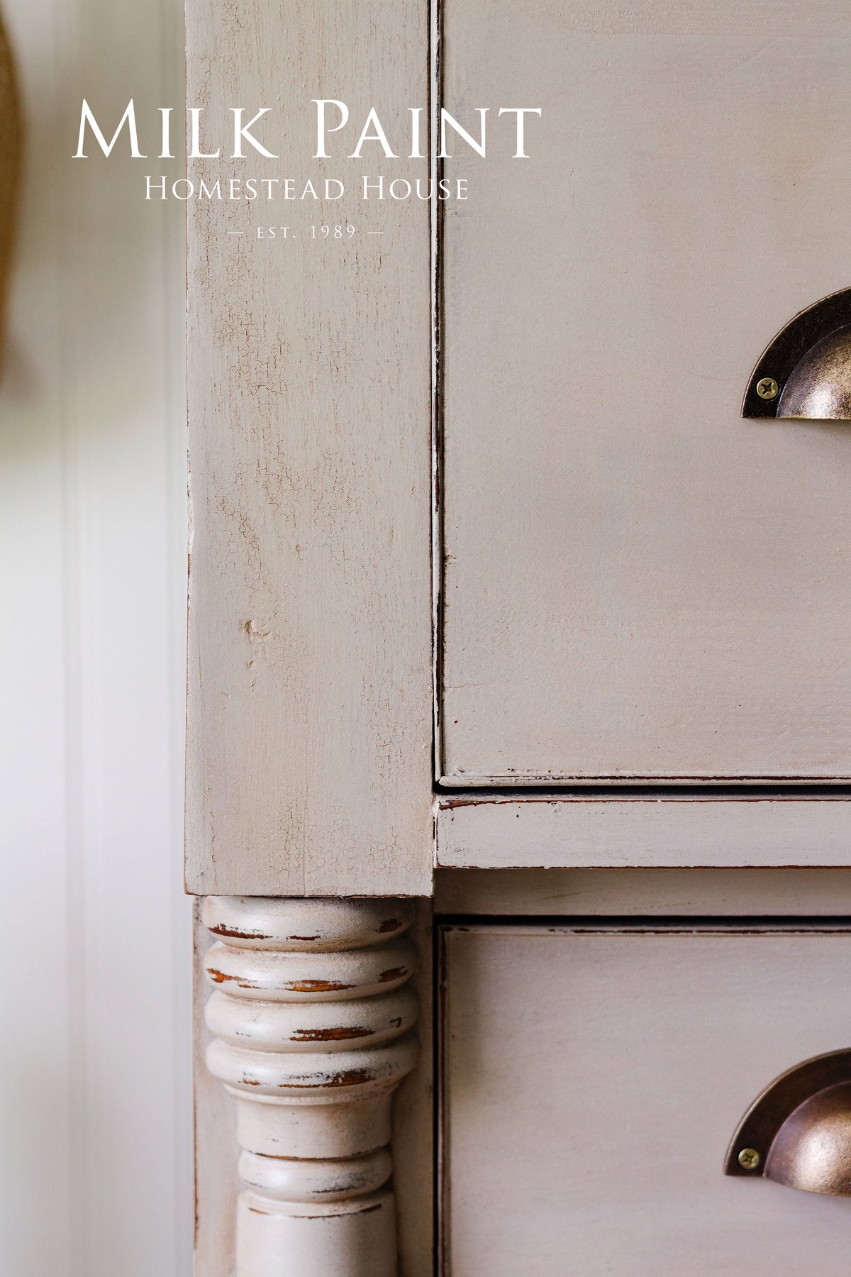 Distressed wood dresser with metal handles, finished in Silhouette Milk Paint by Homestead House.