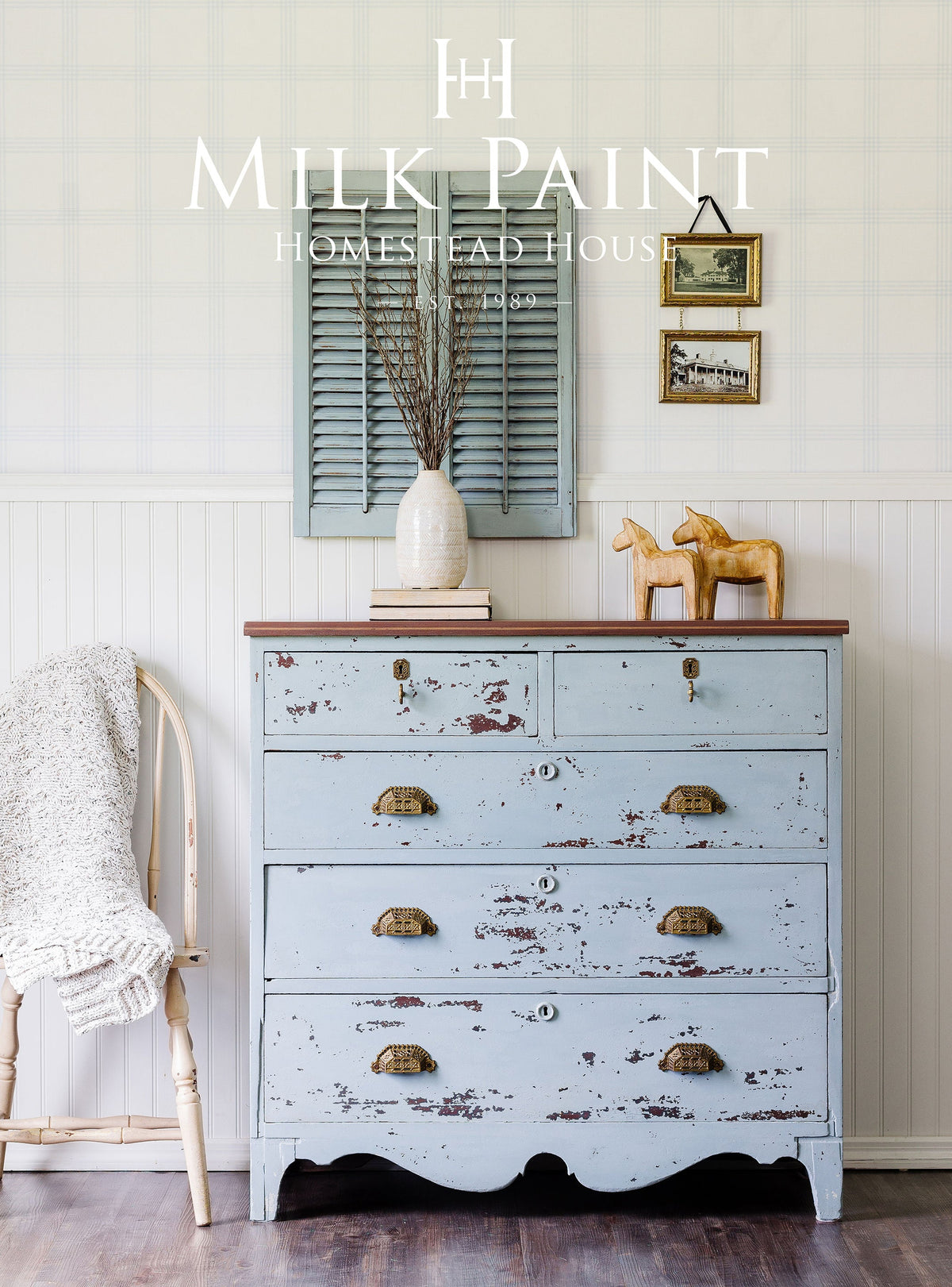 Dresser in Solstice Blue Milk Paint by Homestead House with brass handles, shown next to a cream chair.