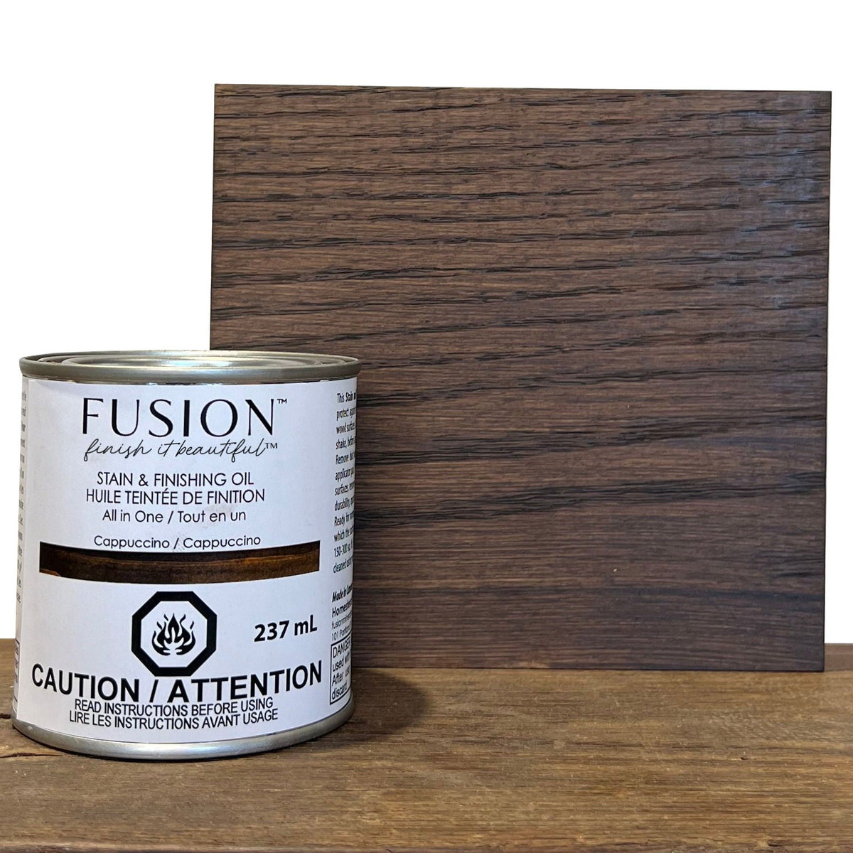 Fusion Mineral Paint Stain & Finishing Oil can beside a wood sample with applied finish.