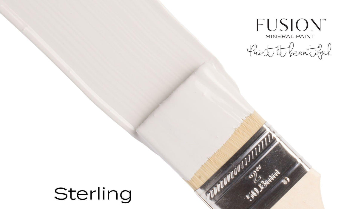 Brush dipped in light gray matte Sterling Fusion Mineral Paint, showing Fusion Mineral Paint branding and tagline.