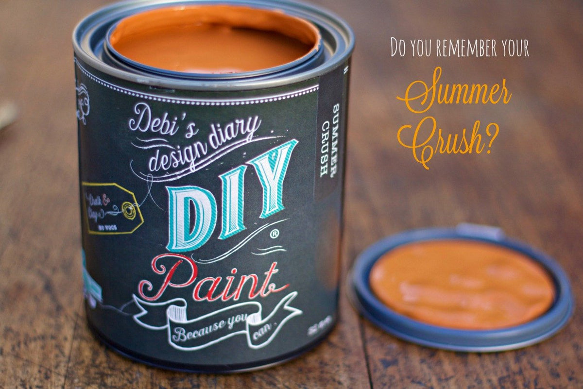 Open can of Summer Crush DIY Paint by DIY Paint Co. on wood, with the lid off and set beside it.