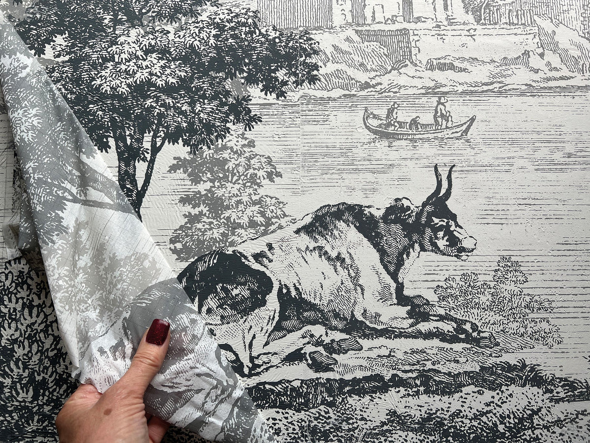 Hand lifting fabric to reveal black-and-white goat print created with Summer Villa Paint Inlay by I.O.D.