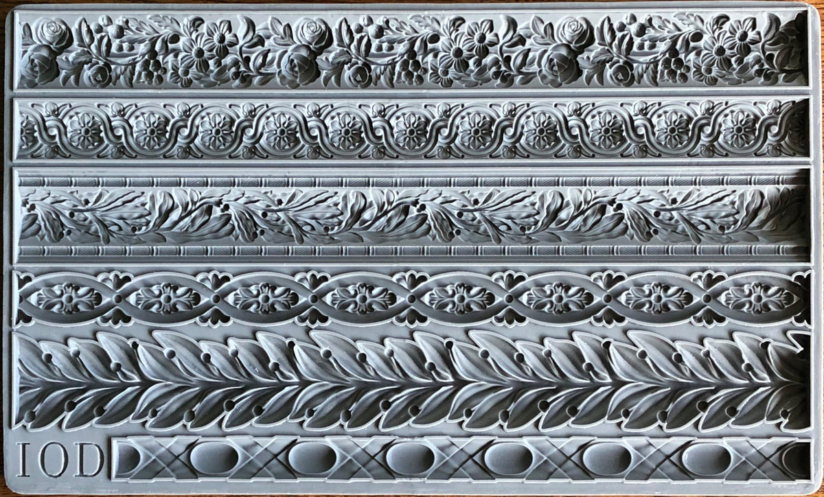 Gray silicone Trimmings 1 Mould by IOD with five rows of ornate floral, leaf, and geometric designs. Brand: I.O.D.