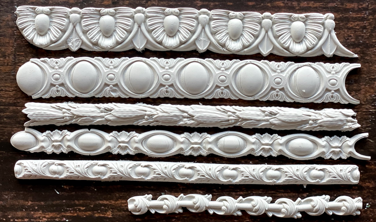 Set of six ornate white trims crafted with I.O.D. Trimmings 3 Mould and air dry clay.