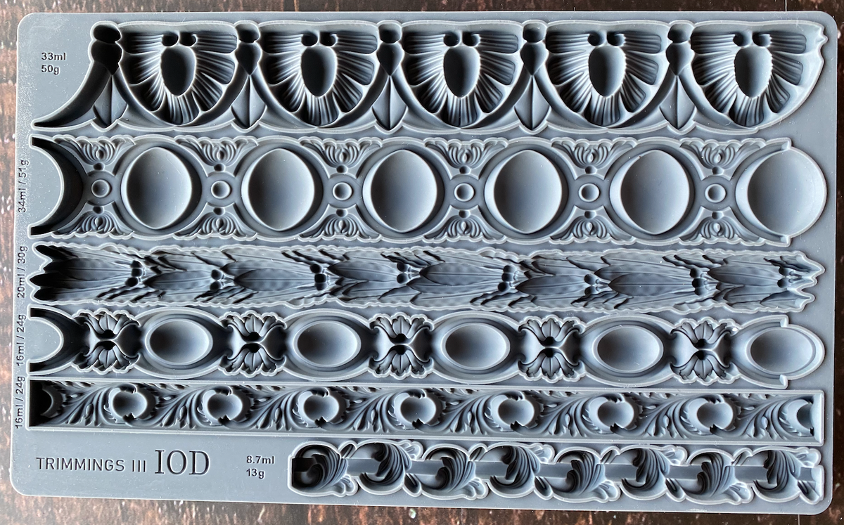 Trimmings 3 Mould by I.O.D. with five ornate borders and measurements displayed on the mould.