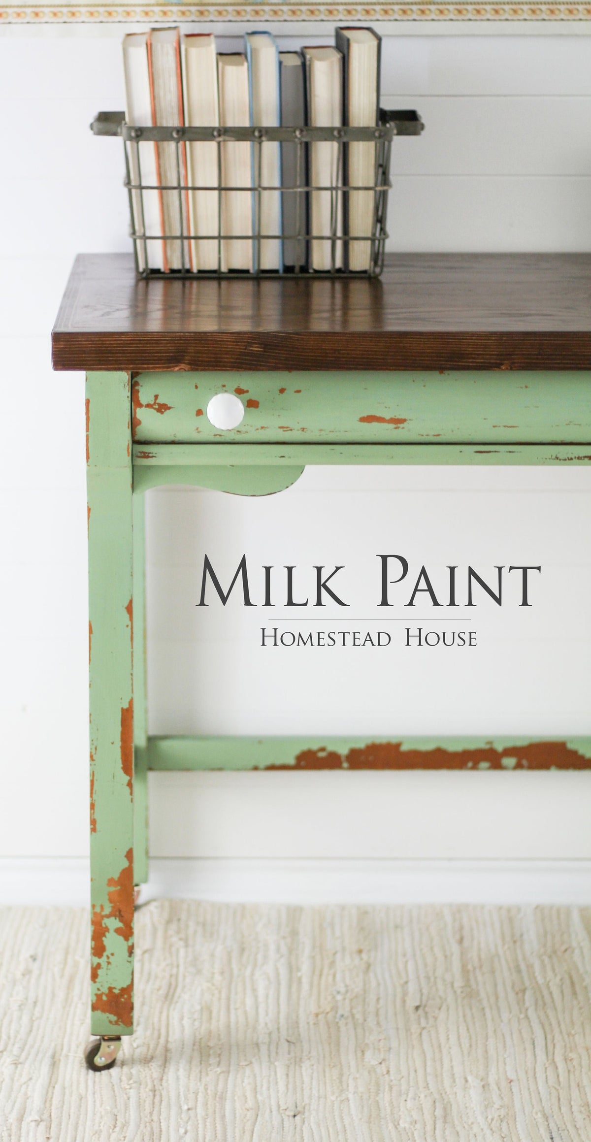 Green distressed desk in Upper Canada Green Milk Paint by Homestead House, dark wood top, books stored below.
