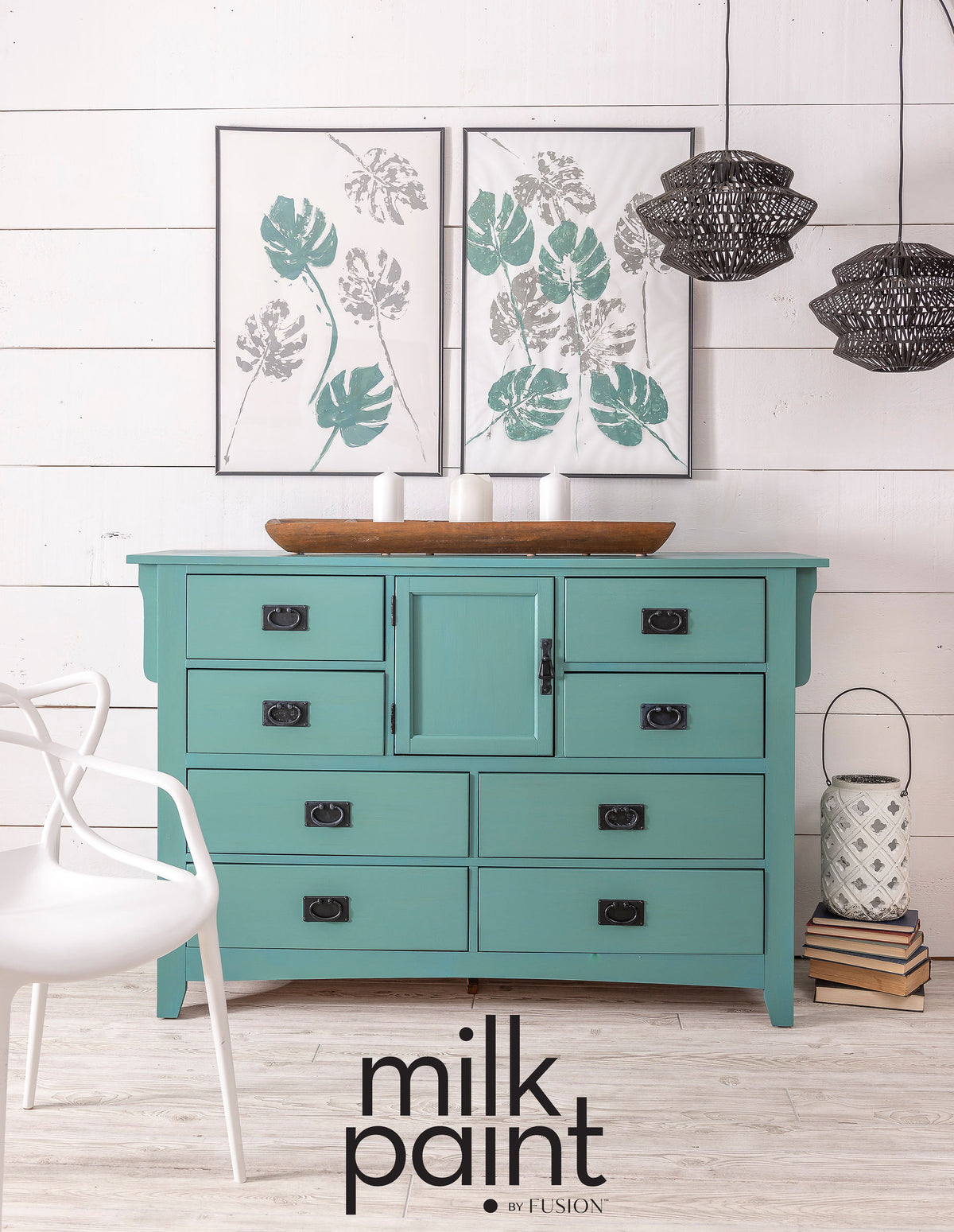 Teal dresser painted with Fusion Mineral Paint Velvet Palm, shown beneath botanical prints with woven pendants nearby.