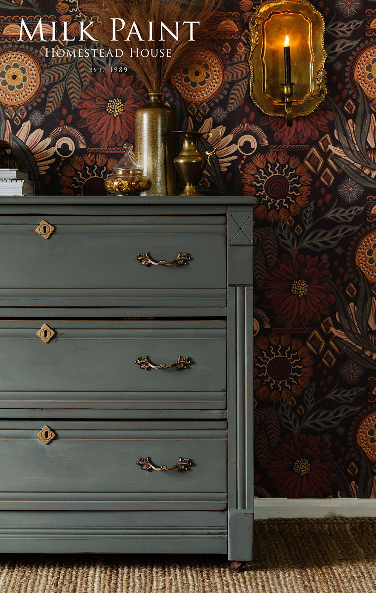 Gray dresser in Homestead House Windsor Green Milk Paint with brass handles and gold accents.