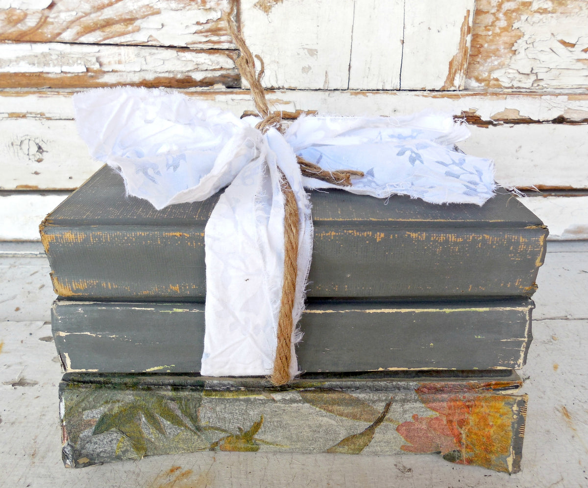 Three old books on rustic wood painted with VOC-free Zinc by Old Fashioned Milk Paint for a vintage look.