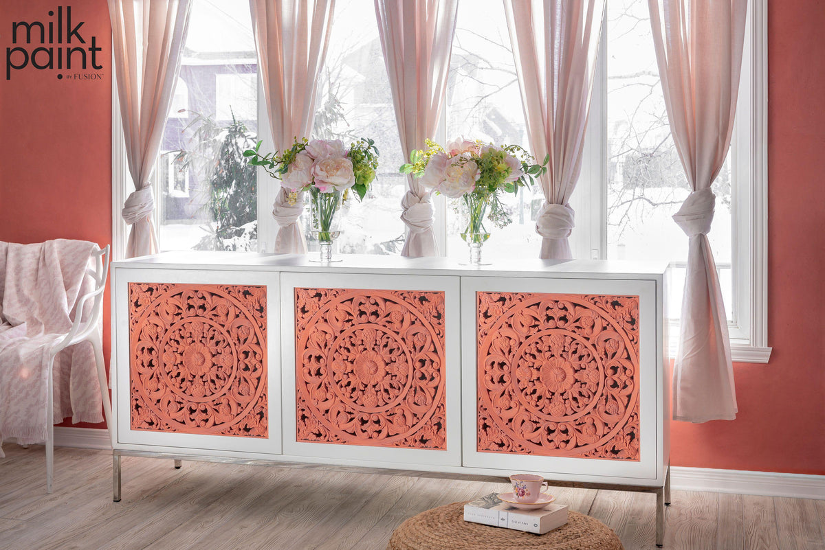 White sideboard painted with Fusion Mineral Paint Casa Rosa Milk Paint, decorated with flowers.