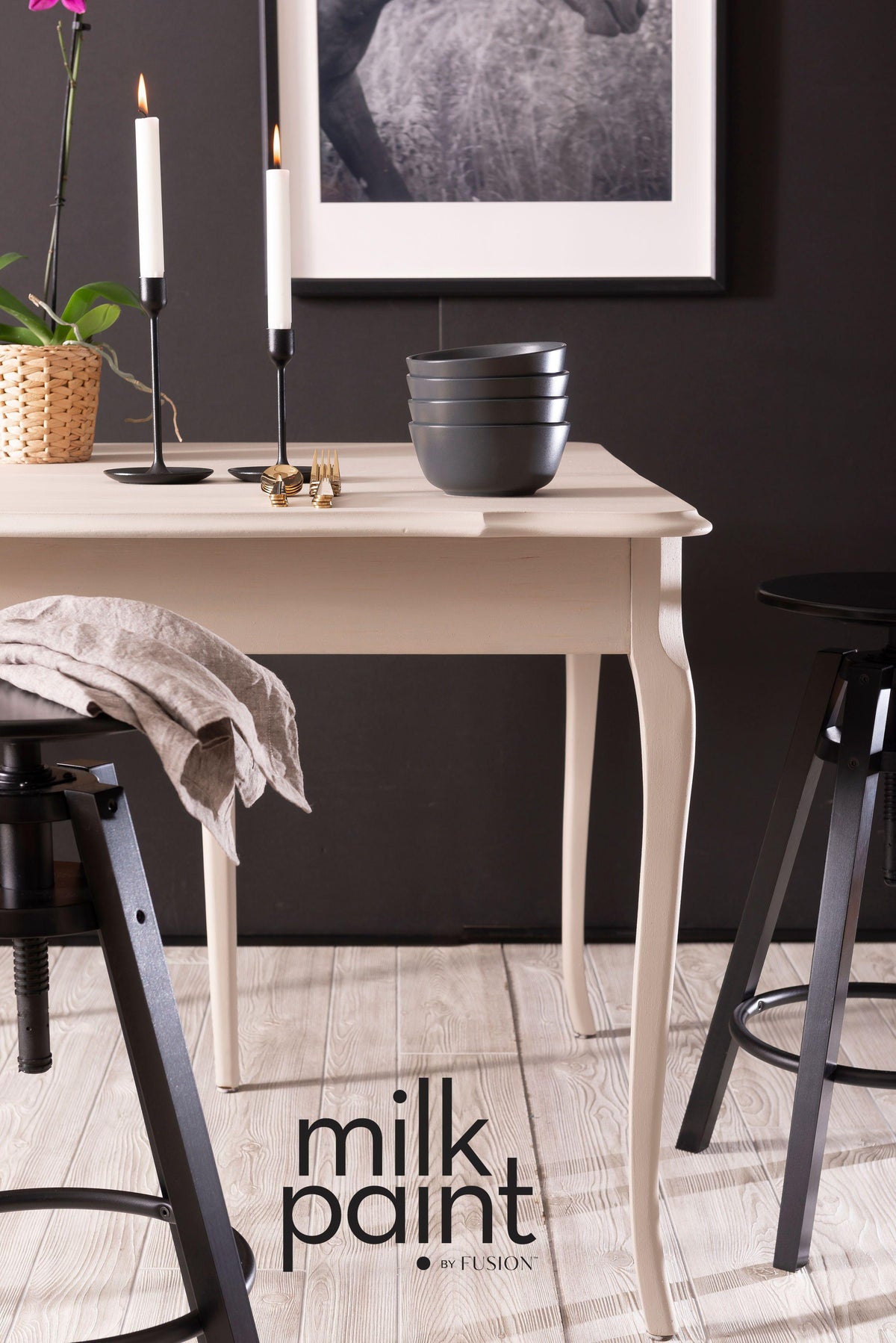 Light wood table with bowls, candles, towel, and “Fusion Mineral Paint Oyster Bar Milk Paint” text on the floor.