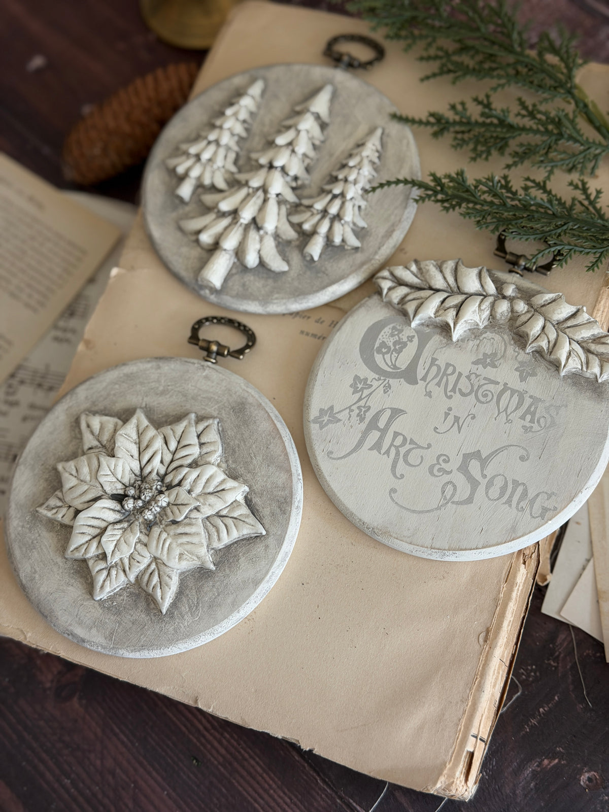 Set of 3 round ornaments featuring trees, poinsettia, and text, made with I.O.D. Boughs of Holly (2026 Limited Release) mould.