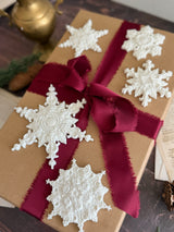 Brown gift box with red ribbon displaying ornaments made from I.O.D. Snowflakes Mould (2026 Limited Release).