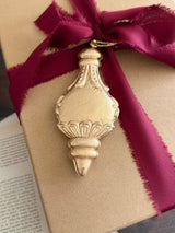 Brown box with burgundy ribbon, topped with I.O.D. Baubles Mould (2026 Limited Release).