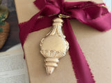 I.O.D. Baubles Mould (2026 Limited Release) on a brown gift box with gold ornament and frayed burgundy ribbon.