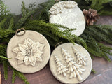 Set of three round ornaments with I.O.D. Boughs of Holly 2026 designs: trees, poinsettia, and text.