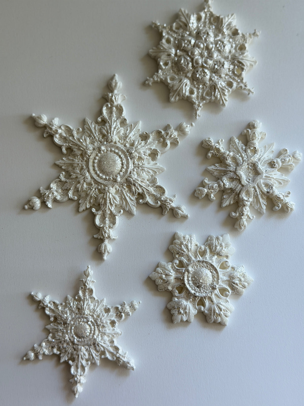 Five detailed I.O.D. Snowflakes Mould (2026 Limited Release) pieces displayed on a light background.