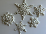Five white I.O.D. Snowflakes Mould (2026 Limited Release) decorations displayed on a plain background.