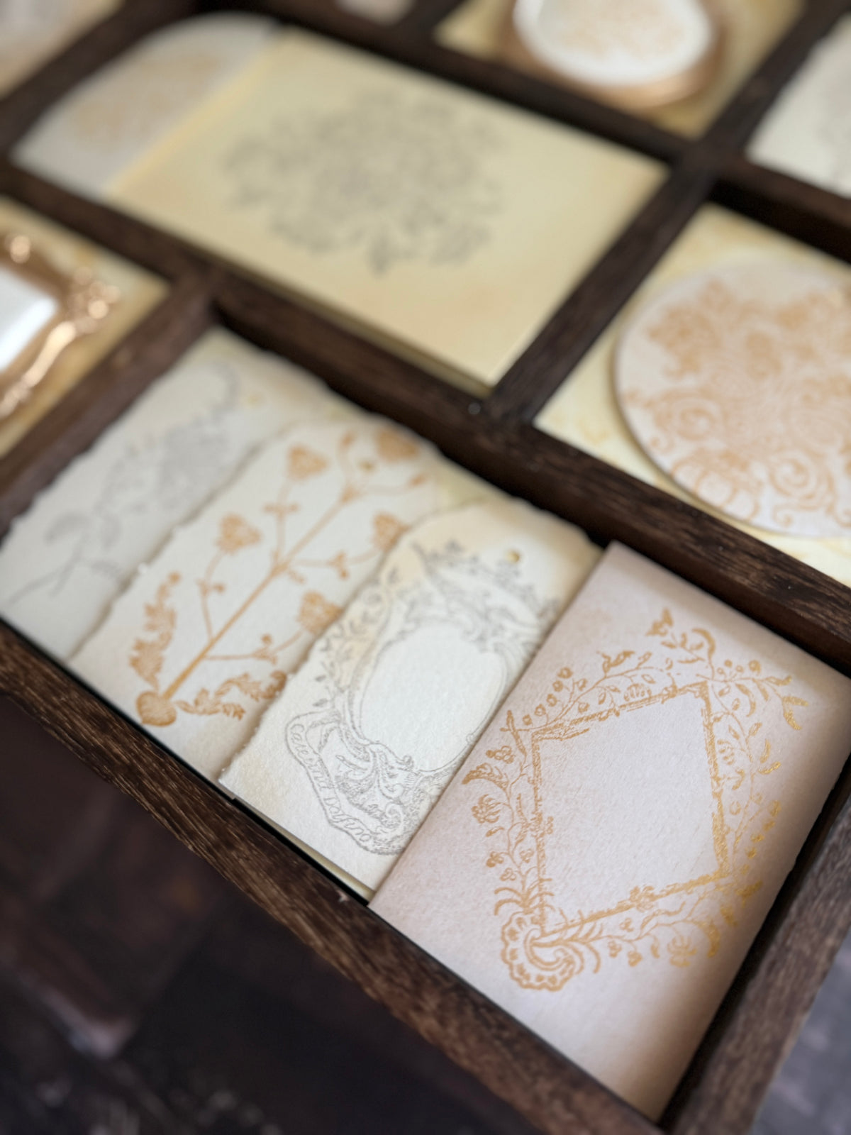 I.O.D. Metallic Ink Pads & Refills in gold shimmer and gray, displayed in a wooden box.