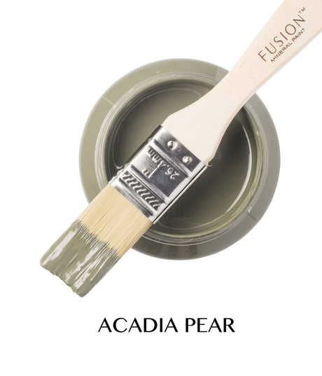 Acadia Pear Fusion Mineral Paint jar in greenish-gray, open with a paintbrush resting on top.