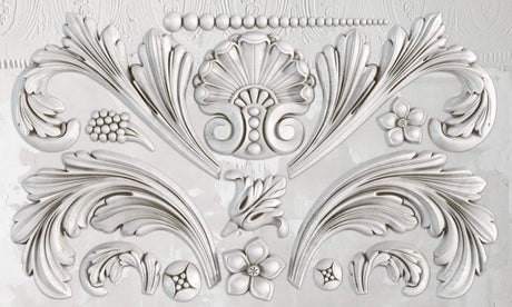 White relief made with I.O.D. Acanthus Scroll Mould, displaying acanthus leaves, flowers, and geometric accents.