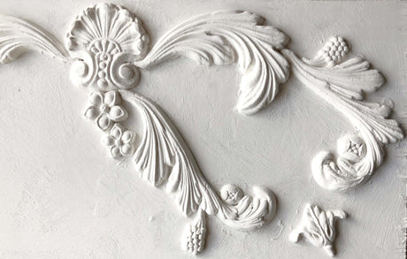 White plaster molding made with I.O.D. Acanthus Scroll Mould and air dry clay, featuring floral designs.