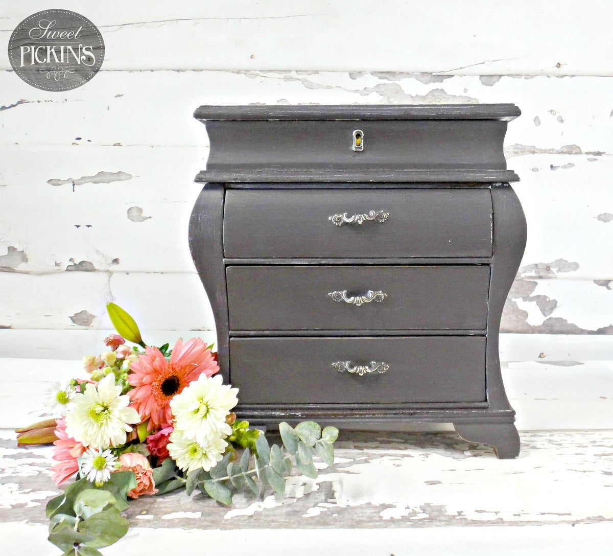 Small chest painted with Old Fashioned Milk Paint Adelaide next to pink and white flowers.