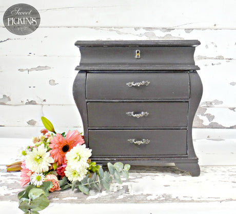 Small chest painted with Old Fashioned Milk Paint Adelaide next to pink and white flowers.