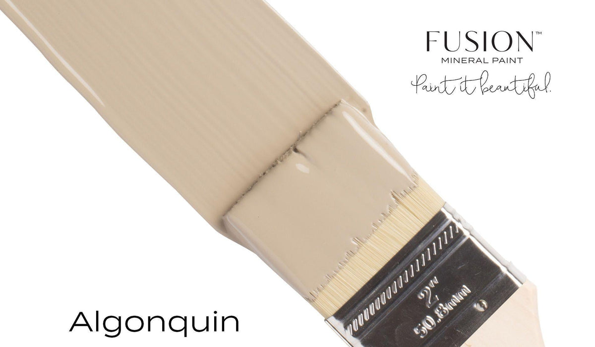 Paintbrush with Algonquin Fusion Mineral Paint in matte beige by Fusion Mineral Paint on a white background.