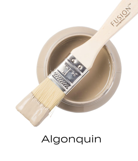 Brush with deep taupe paint on open jar of Fusion Mineral Paint Algonquin, showing the matte finish.