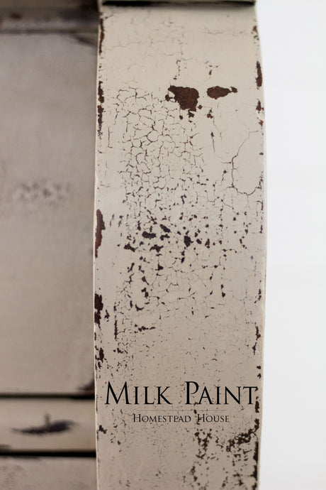 Cracked, peeling Algonquin Milk Paint by Homestead House with visible logo text.