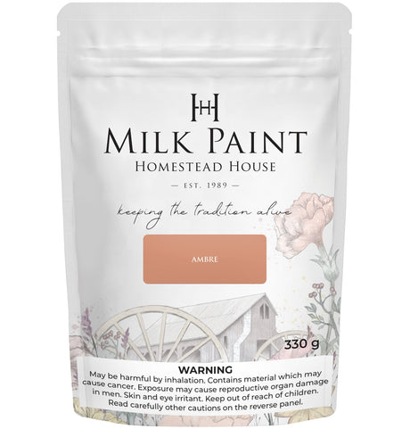 330g Homestead House Amber Milk Paint pouch with rustic wagon and flower graphic on the front.