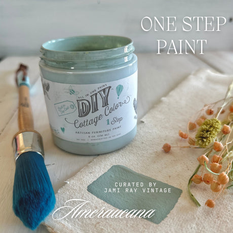 Open jar of Ameraucana DIY Cottage Color by DIY Paint Co. with brush, dried flowers, and blue paint swatch.