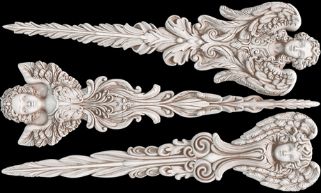 Three light wood carvings with feathers, foliage, and cherub faces from the IOD Angelic Tapers Mould on black background.
