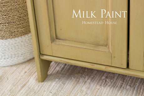 Yellow cabinet in Antique Gold Milk Paint by Homestead House on a woven rug, text: Homestead House.
