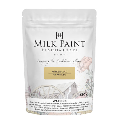 330g Antique Gold Milk Paint by Homestead House with rustic wheelbarrow art and clear safety warning on bag.