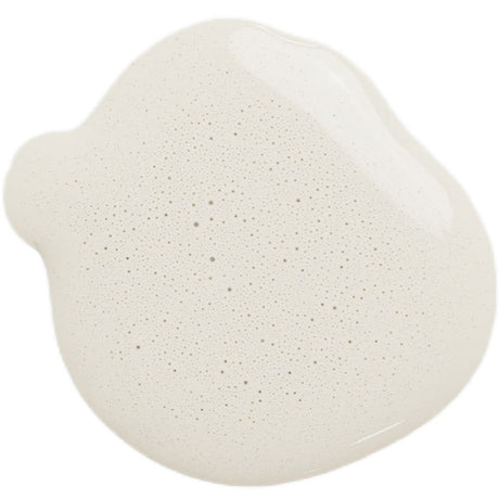 Round beige foamy spill on white surface, resembling Old Fashioned Milk Paint Antique Ironstone color.