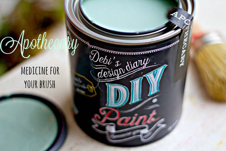 Open can of Apothecary DIY Paint by DIY Paint Co. with brush; visible text: “Medicine for your brush.”.