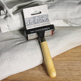 I.O.D. Art Brayer by Iron Orchid Designs shown resting on folded fabric.