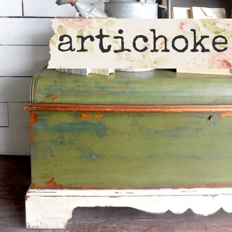 Green wooden bench with chipped Old Fashioned Milk Paint and Artichoke sign.