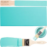 Azure Fusion Mineral Paint jar with paint stirrer, brush, and wood sample.