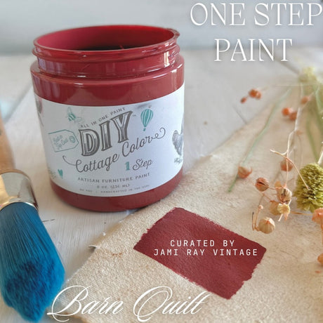 DIY Paint Co. Barn Quilt Cottage Color jar with blue brush, dried flowers, and fabric swatch showing the hue.