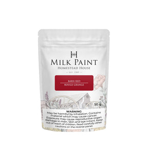 50g Barn Red Milk Paint by Homestead House with warning label and barn plus wagon wheel illustration on packaging.