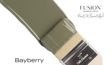Paintbrush with Fusion Mineral Paint Bayberry shade on bristles, displayed against a white background.