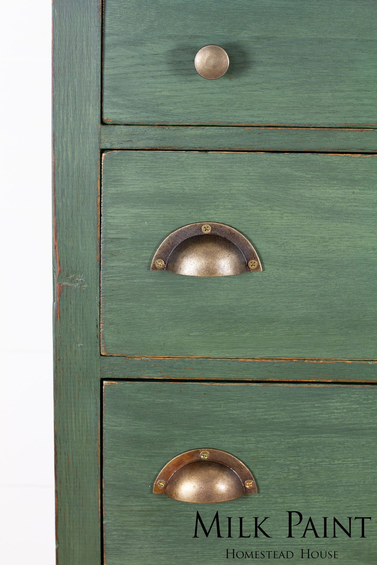 Green wooden dresser with three drawers, brass handles, painted in Homestead House Bayberry Milk Paint.